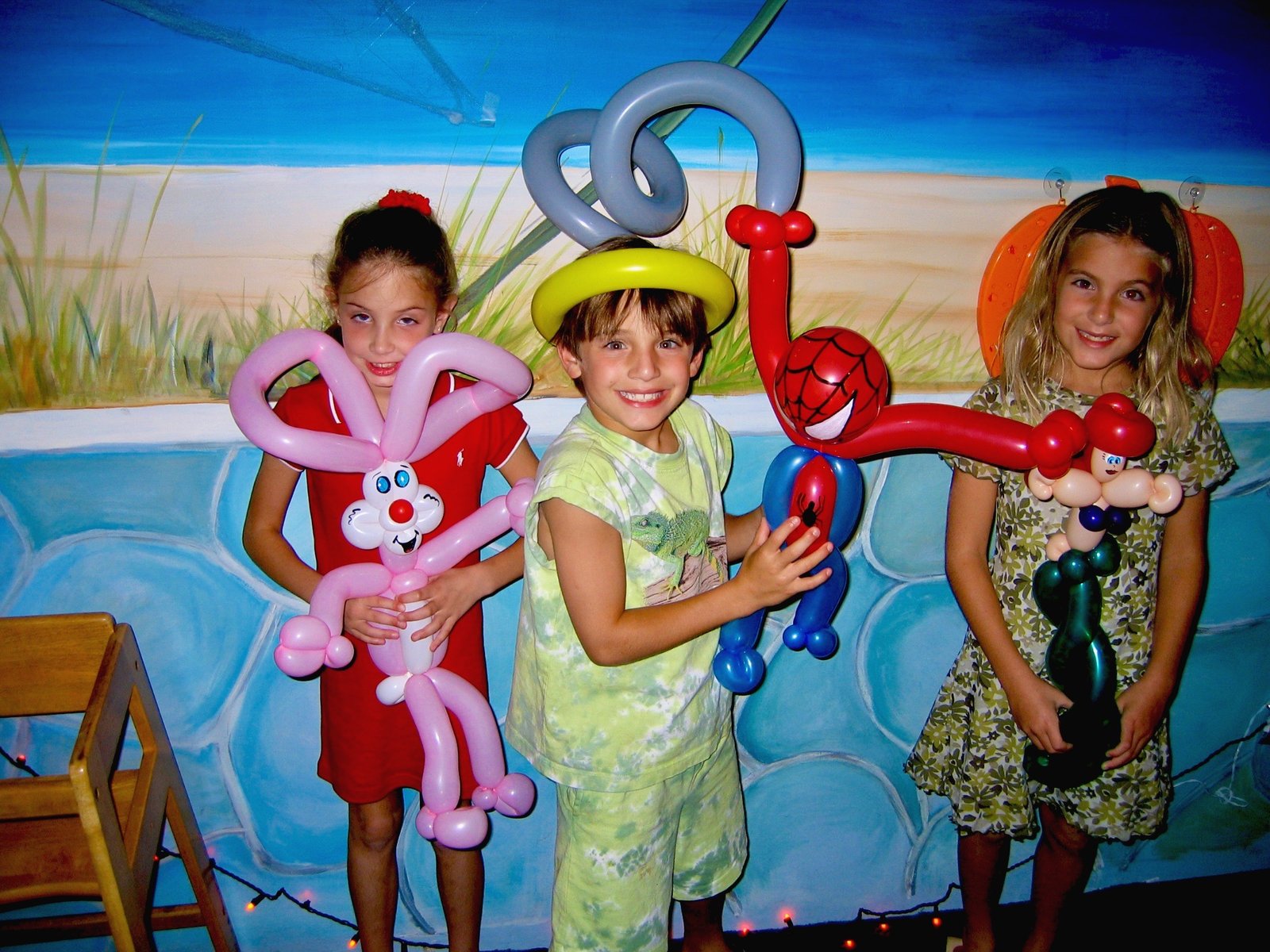 Children enjoying colorful balloon animals at event