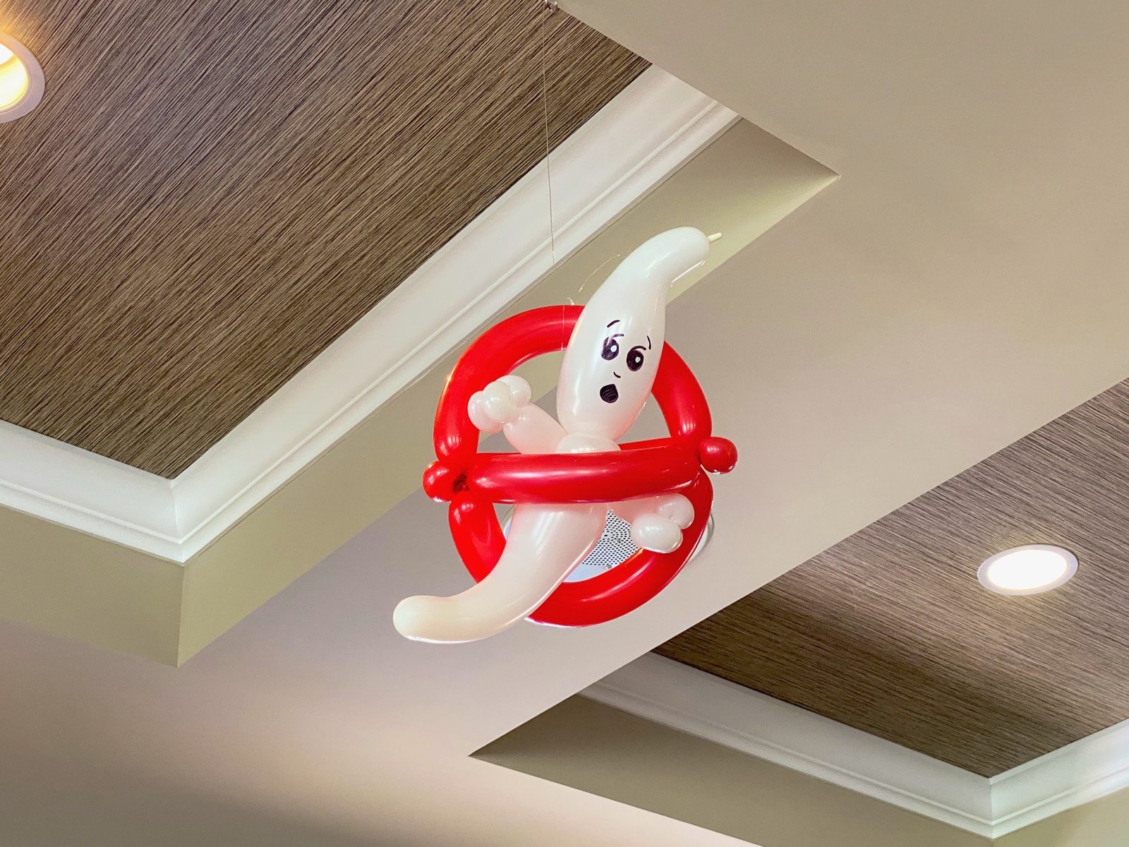 Elegant Halloween balloon installation at a Florida venue with dark jewel tones