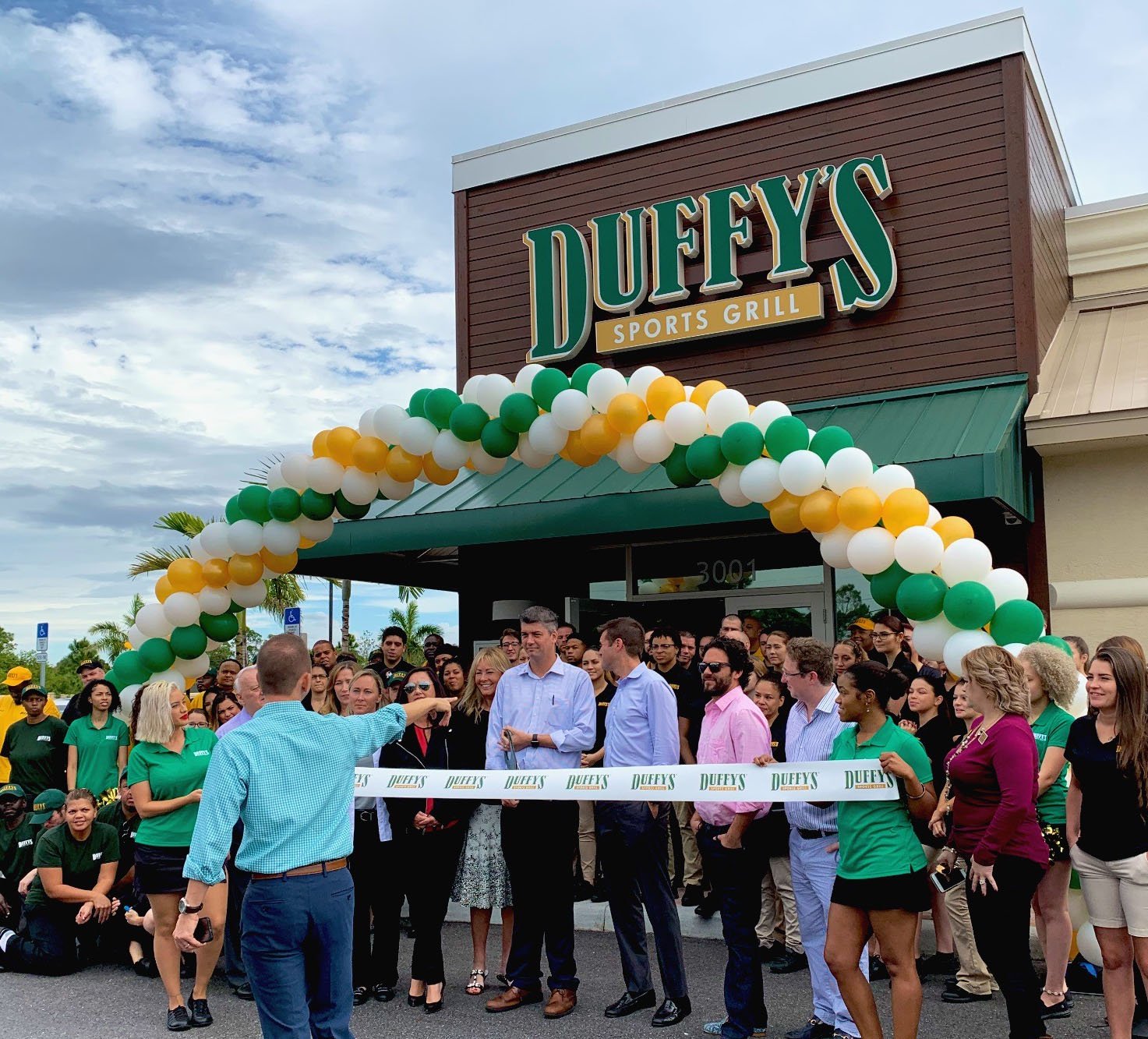 Grand opening event with balloon decor at sports grill