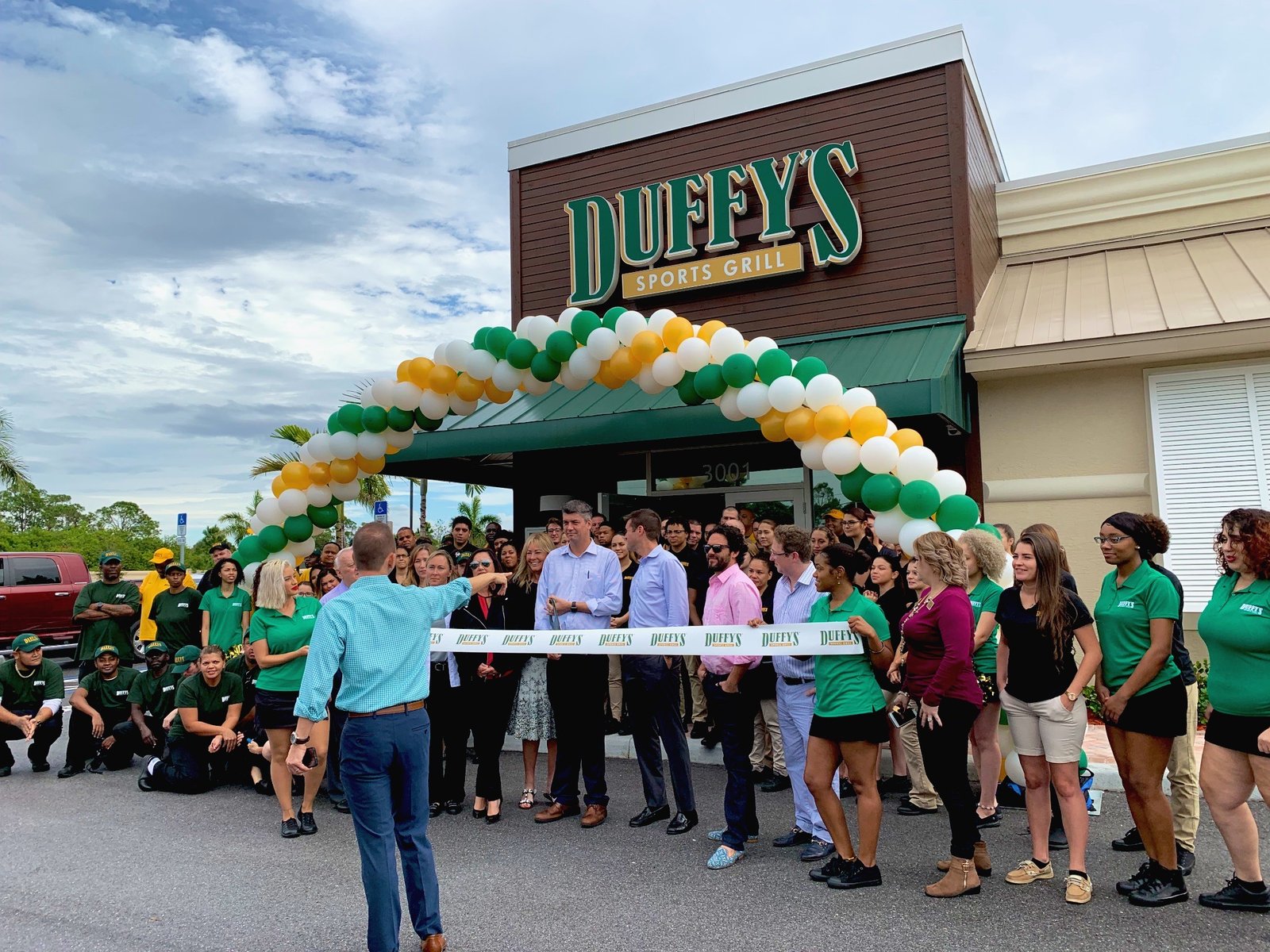 Auto dealership grand opening event with entertainment and decor