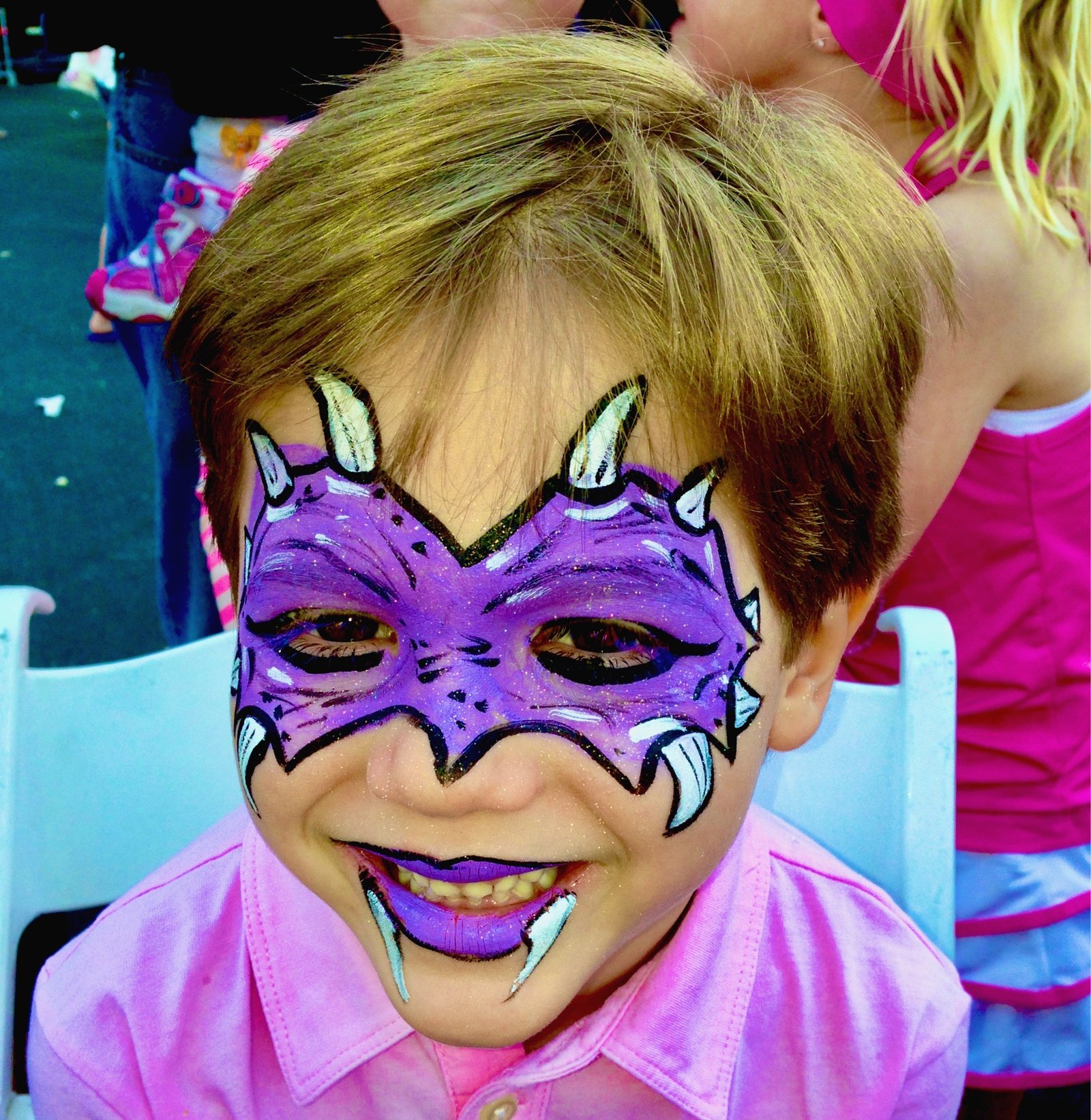 Child with professional purple face paint design